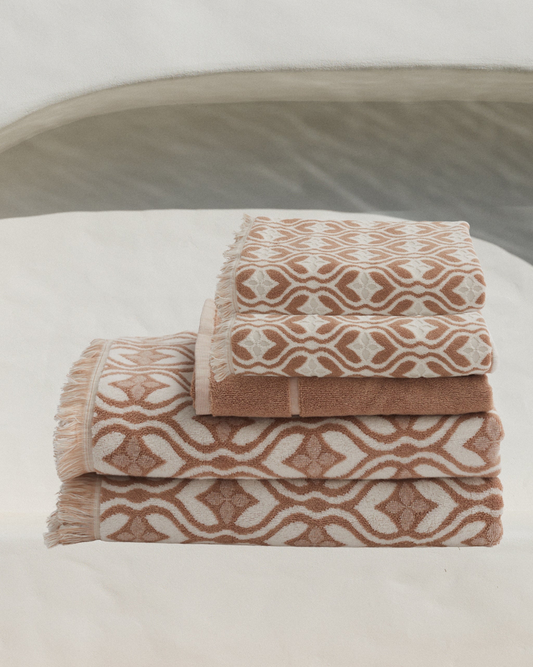 a set of stone coloured pattern towels for the bathroom 